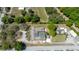 Aerial view of house, pool, and large lot with mature trees at 8723 A D Mims Rd, Orlando, FL 32818