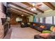 Spacious Gathering room with a large sectional sofa, exposed beams, and a brick fireplace at 8723 A D Mims Rd, Orlando, FL 32818