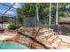 Multi-tiered stone waterfall cascades into a refreshing pool at 8723 A D Mims Rd, Orlando, FL 32818