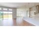 Open concept kitchen and dining area with modern white cabinets and tile floors at 389 Mosaic Blvd, Daytona Beach, FL 32124