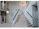 Elegant staircase with white railings and carpeted steps at 1557 Amaryllis Cir, Orlando, FL 32825