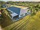 Aerial view of home with screened porch and large yard at 6990 Orlando Dr # A, Indian Lake Estates, FL 33855