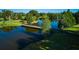 Picturesque bridge spanning a calm pond reflecting the surrounding trees at 3681 Gardenia Dr, Indian Lake Estates, FL 33855