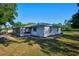 Ranch style home with side view showcasing a screened porch at 3681 Gardenia Dr, Indian Lake Estates, FL 33855