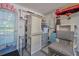 Organized garage with shelving, cabinets, and mini-fridge at 3681 Gardenia Dr, Indian Lake Estates, FL 33855