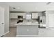 Modern kitchen with white cabinets, stainless steel appliances, and an island at 472 Waterford Dr, Lake Alfred, FL 33850