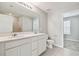 Modern bathroom with double vanity, a large mirror, and a shower at 472 Waterford Dr, Lake Alfred, FL 33850