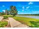Peaceful lakeside walkway with scenic views and lush landscaping at 625 Legacy Park Dr, Casselberry, FL 32707