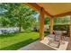 Relaxing patio overlooking a pond, featuring a grill and seating area at 625 Legacy Park Dr, Casselberry, FL 32707
