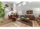 Spacious living room featuring hardwood floors, a large sofa, and high ceilings at 625 Legacy Park Dr, Casselberry, FL 32707