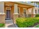 Inviting front porch with dark brown door and lush green bushes at 625 Legacy Park Dr, Casselberry, FL 32707