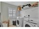 Bright laundry room with washer, dryer, and ample shelving at 625 Legacy Park Dr, Casselberry, FL 32707