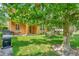 Landscaped backyard with patio, seating, and grill near large tree at 625 Legacy Park Dr, Casselberry, FL 32707