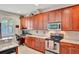 Kitchen boasts granite countertops and wood cabinetry at 625 Legacy Park Dr, Casselberry, FL 32707