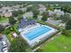 Community pool with plenty of lounge chairs and a playground nearby at 625 Legacy Park Dr, Casselberry, FL 32707