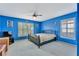 Blue bedroom with a ceiling fan and large windows at 625 Legacy Park Dr, Casselberry, FL 32707