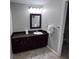Bathroom with dark wood vanity and granite countertop at 14501 Grove Resort Ave # 1617, Winter Garden, FL 34787