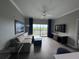 Spacious living room with wood-look floors, large window, and balcony view at 14501 Grove Resort Ave # 1617, Winter Garden, FL 34787