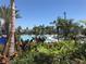 Inviting pool area with tropical landscaping and lounge chairs at 14501 Grove Resort Ave # 1617, Winter Garden, FL 34787