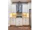 Modern kitchen with stainless steel range hood and granite countertops at 8339 Bridgeport Bay Cir, Mount Dora, FL 32757