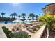 Community pool with lounge chairs and umbrellas at 2705 Bushman Dr, Kissimmee, FL 34746