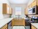 Well-equipped kitchen with light wood cabinets and a breakfast bar at 2705 Bushman Dr, Kissimmee, FL 34746