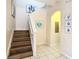Modern staircase with wood-look flooring and artwork at 2705 Bushman Dr, Kissimmee, FL 34746