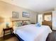 Spacious main bedroom with a comfortable king-size bed and en-suite bathroom at 2705 Bushman Dr, Kissimmee, FL 34746