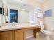 Clean bathroom with a toilet, sink, and vanity at 2705 Bushman Dr, Kissimmee, FL 34746