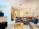 Spacious living room with seating and stairs at 2705 Bushman Dr, Kissimmee, FL 34746