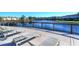 Expansive deck overlooking a lake with lounge chairs at 2705 Bushman Dr, Kissimmee, FL 34746