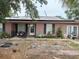 Ranch-style home with solar panels and needs landscaping at 136 Madera Dr, Winter Haven, FL 33880