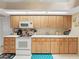 Bright kitchen with white appliances and wood cabinets at 2163 Rainbower Ct, Lakeland, FL 33810