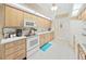 Eat-in kitchen with white appliances and wood cabinets at 2163 Rainbower Ct, Lakeland, FL 33810