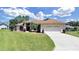 Single-story house with two-car garage and landscaping at 2163 Rainbower Ct, Lakeland, FL 33810