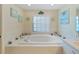 Spacious bathroom with a large soaking tub and separate shower at 2163 Rainbower Ct, Lakeland, FL 33810