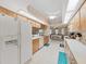 Clean kitchen featuring white appliances and wood cabinetry at 2163 Rainbower Ct, Lakeland, FL 33810