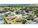 An aerial view of a house with a pool in a quiet residential neighborhood at 2163 Rainbower Ct, Lakeland, FL 33810