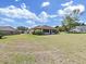 Large backyard with green grass and home view at 2163 Rainbower Ct, Lakeland, FL 33810