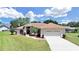 Single-story house with two-car garage and landscaping at 2163 Rainbower Ct, Lakeland, FL 33810
