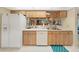 Kitchen with white appliances and wood cabinets at 2163 Rainbower Ct, Lakeland, FL 33810
