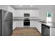 Modern kitchen with stainless steel appliances and light wood flooring at 15271 Sw 65Th Terrace Rd, Ocala, FL 34473