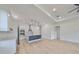 Open concept kitchen with white shaker cabinets and stainless steel appliances at 485 Adams View Ln, Auburndale, FL 33823