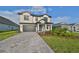 Two-story home with a gray brick driveway at 485 Adams View Ln, Auburndale, FL 33823