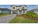 Two-story home with a gray brick driveway at 485 Adams View Ln, Auburndale, FL 33823