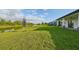 Spacious backyard with lush grass and a peaceful lake view at 485 Adams View Ln, Auburndale, FL 33823
