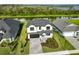 Stunning aerial view of a two-story home with lake access at 485 Adams View Ln, Auburndale, FL 33823