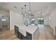 Modern kitchen with a large island, stainless steel appliances, and white cabinetry at 485 Adams View Ln, Auburndale, FL 33823