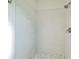 Clean shower with white tile, pebble floor and modern fixtures at 485 Adams View Ln, Auburndale, FL 33823