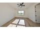 Bright bedroom with hardwood floors, large window and ceiling fan at 485 Adams View Ln, Auburndale, FL 33823